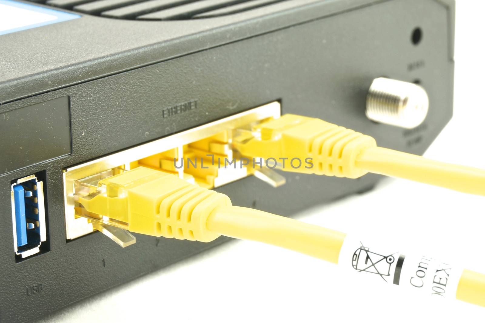 Cable modem router have yellow lan cable connected to port.