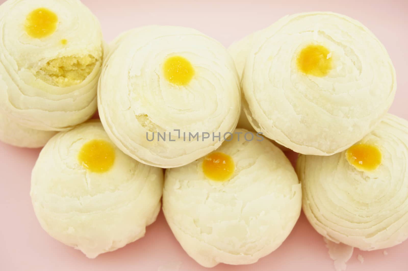 Close up chinese pastry place on a pink tray with wood background.