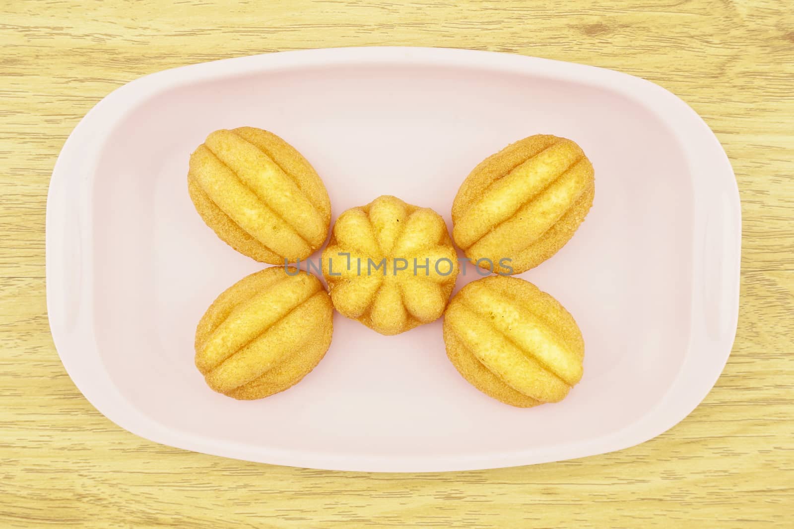 Egg cake is thai bakery put on pink tray with wood background.