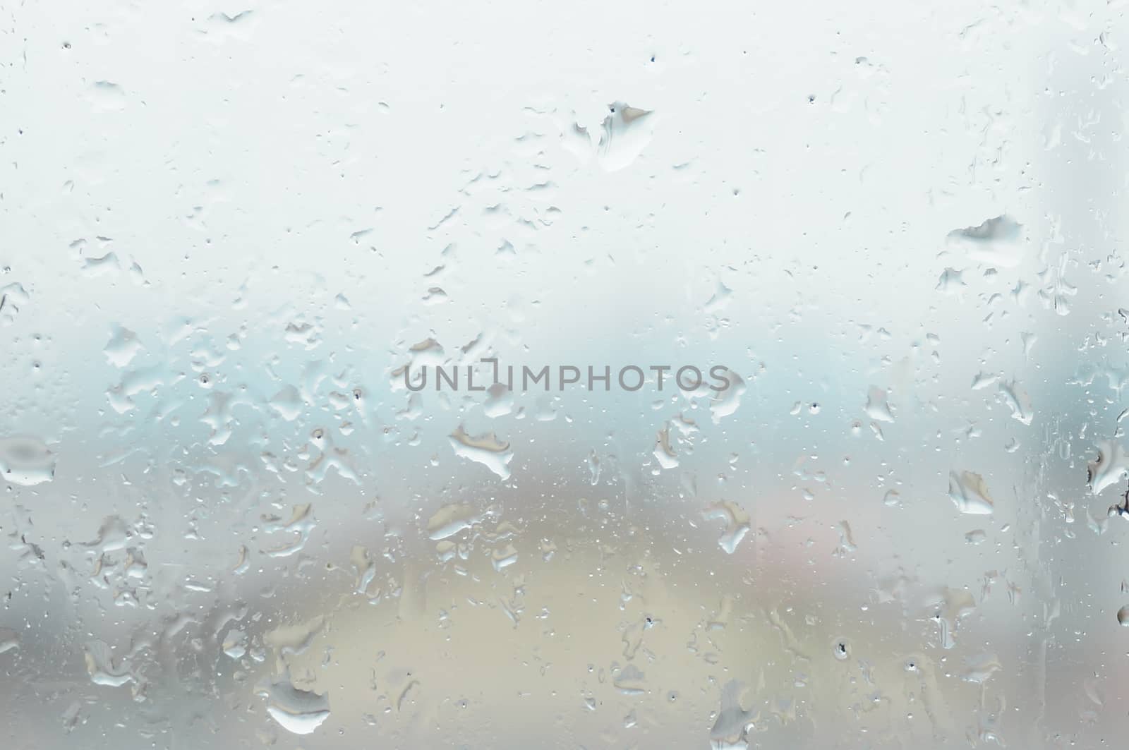 Window glass with water vapor and raindrop during a rainstorm.