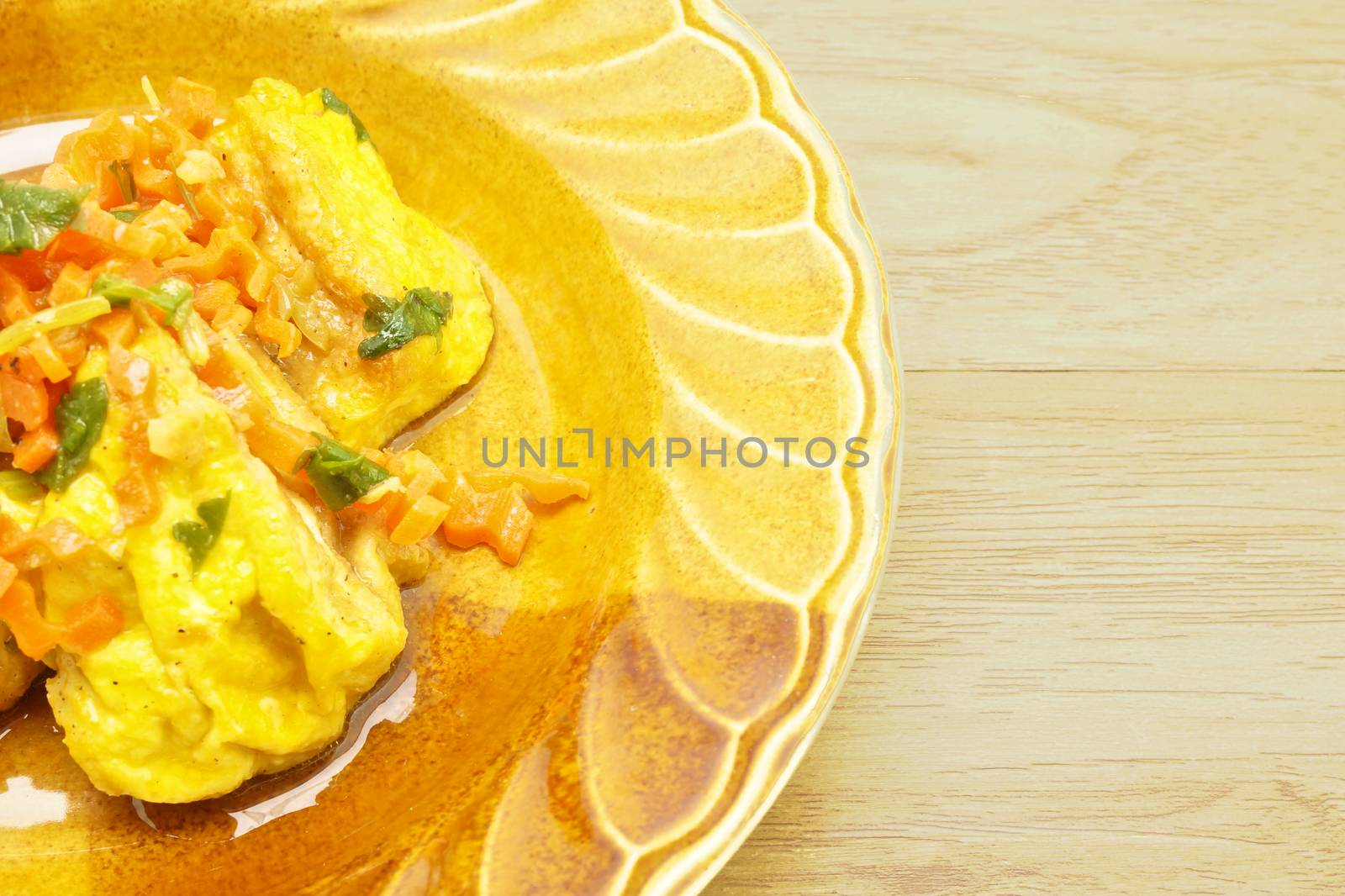 Yellow tofu fried carrot and celery on wood background by eaglesky