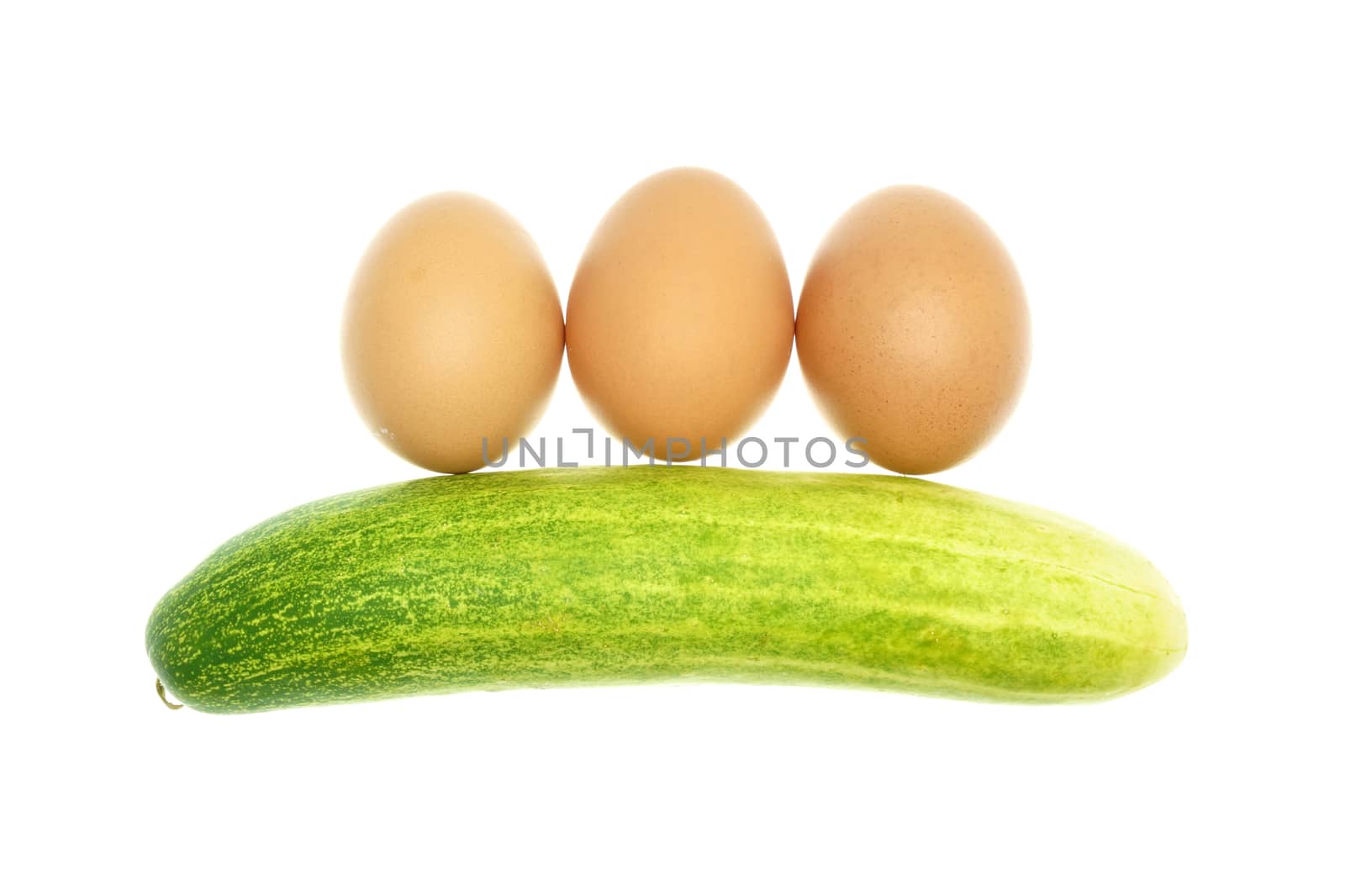 Egg put as straight and cucumber isolated with white background.