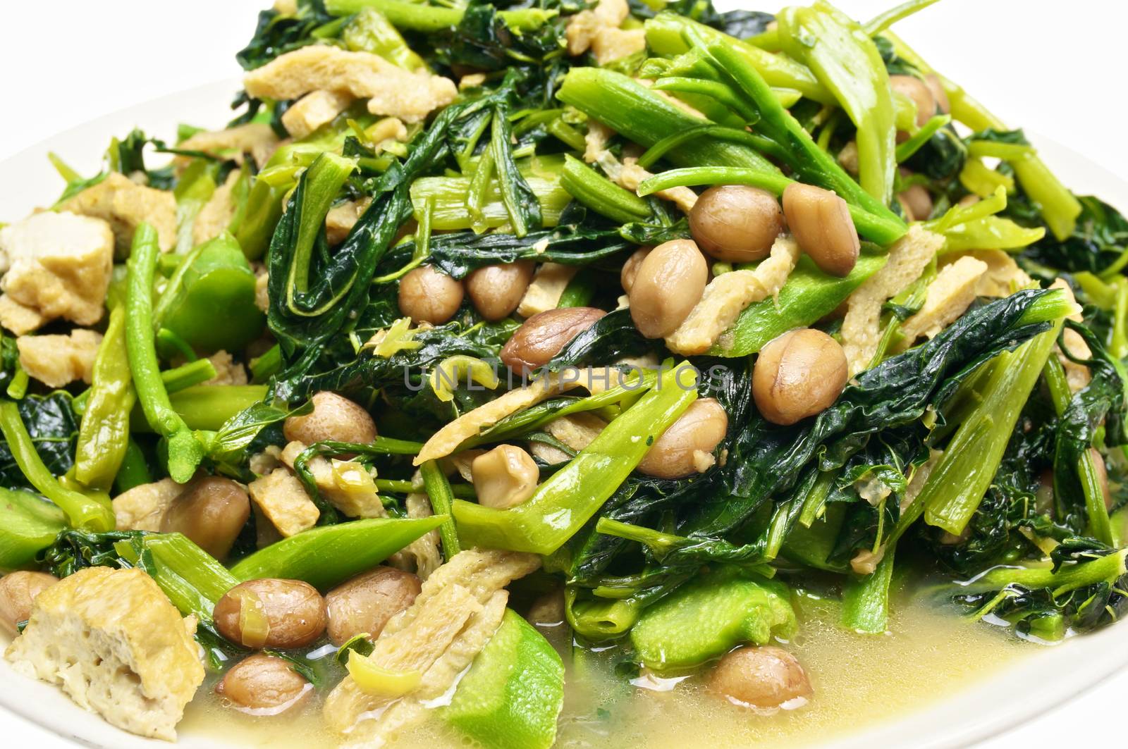 Closeup morning glory and spinach fried with tofu, groundnut and Champignon mushroom.