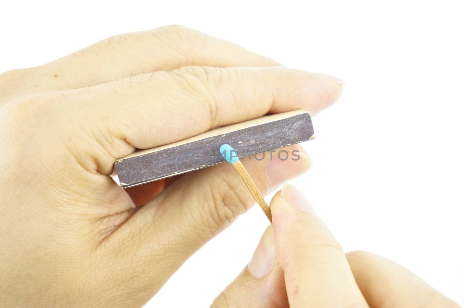 Hand hold blue matchstick for lit and box isolated with white background.