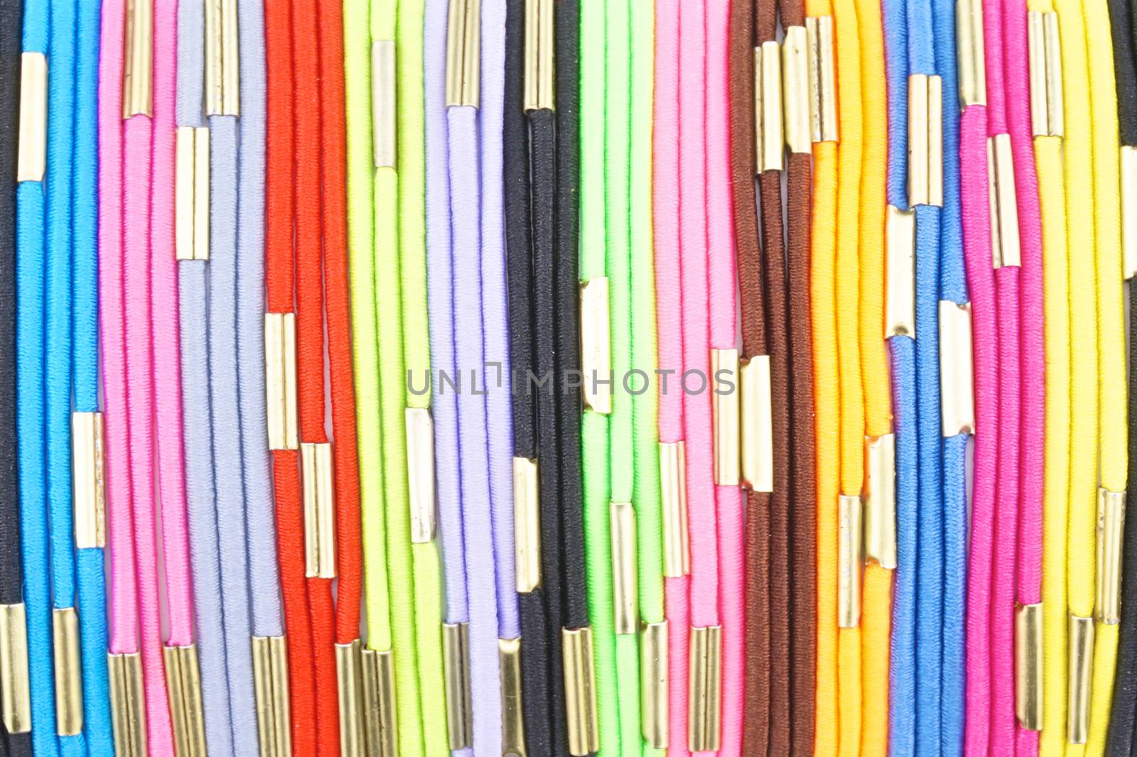 Colorful hair band made from  elastic rubber connect with gold iron place as pattern.