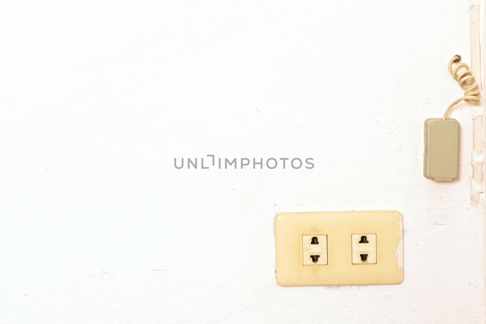 Old plug and phone connect box on wall by eaglesky