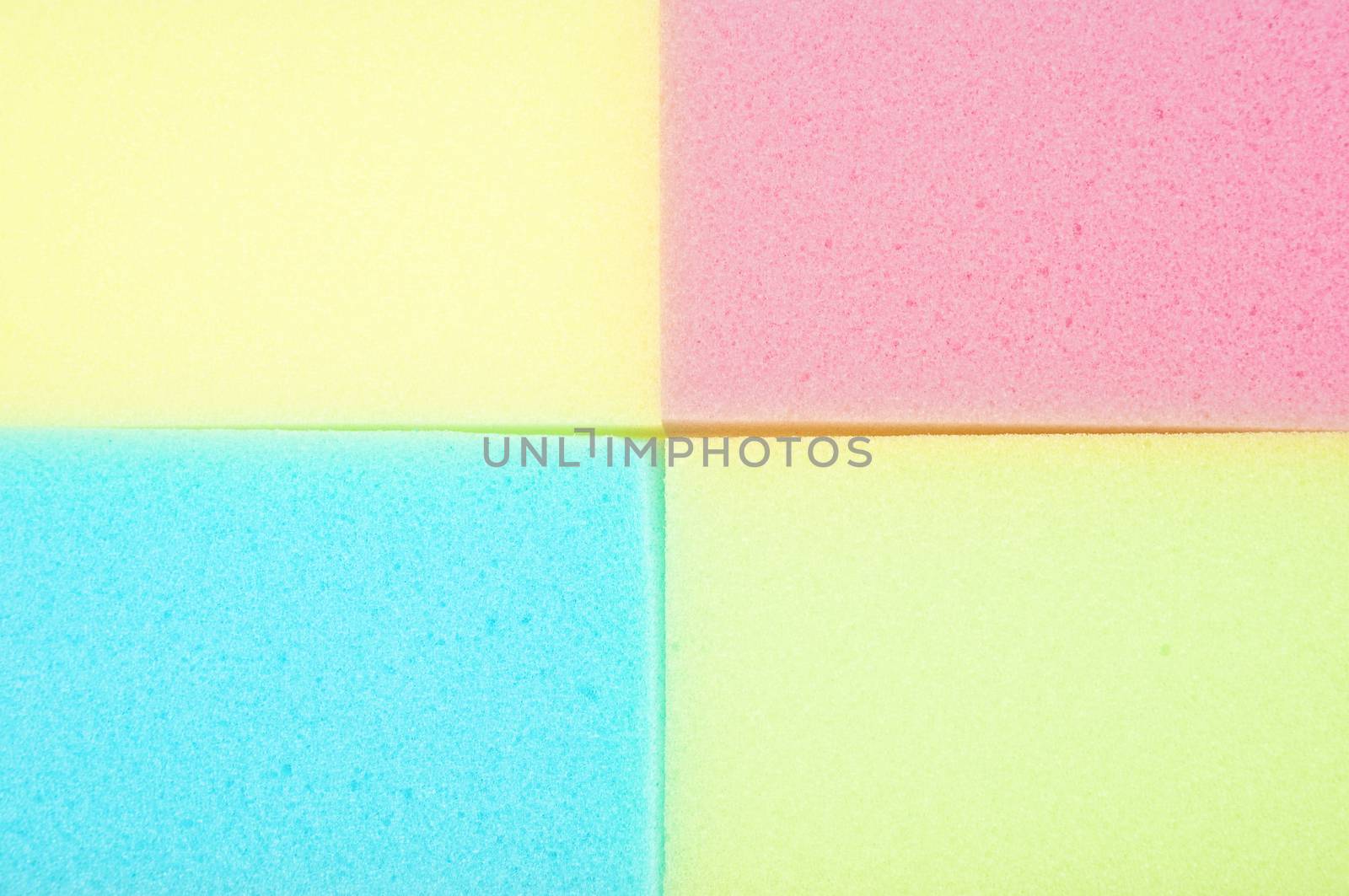 Pink, blue and yellow sponge for clean place as texture background.