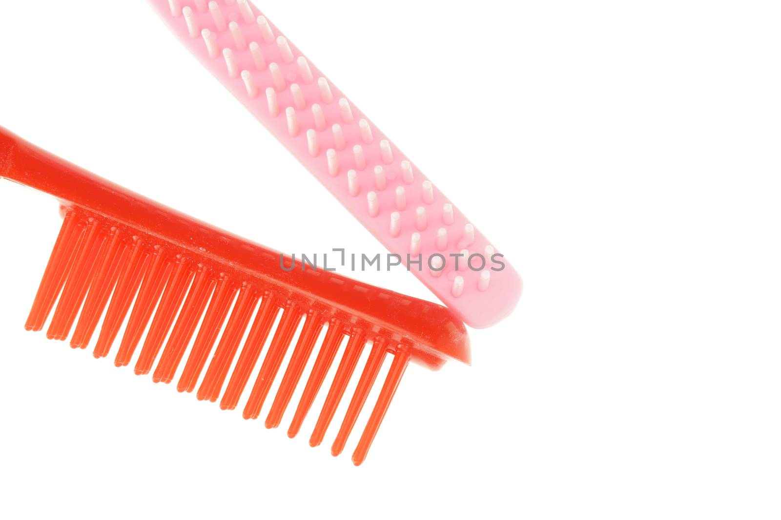 Red and pink comb different size isolated with white background.