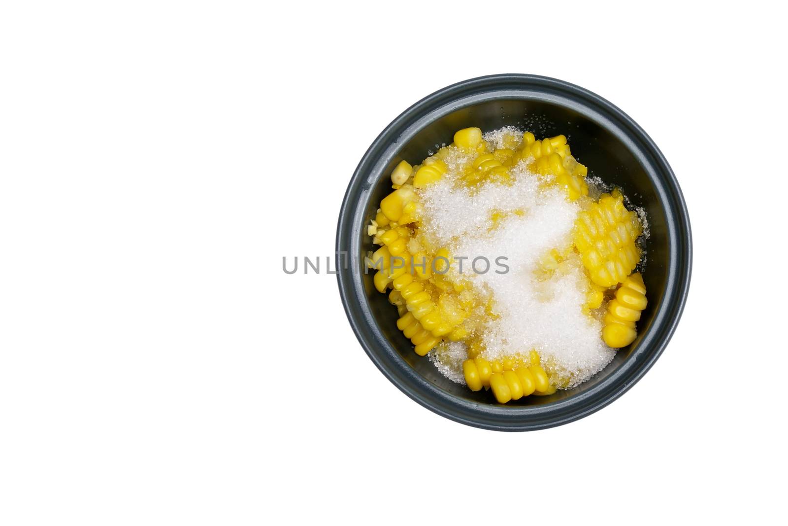 Shear corn with sugar and salt in bowl isolated with white background.