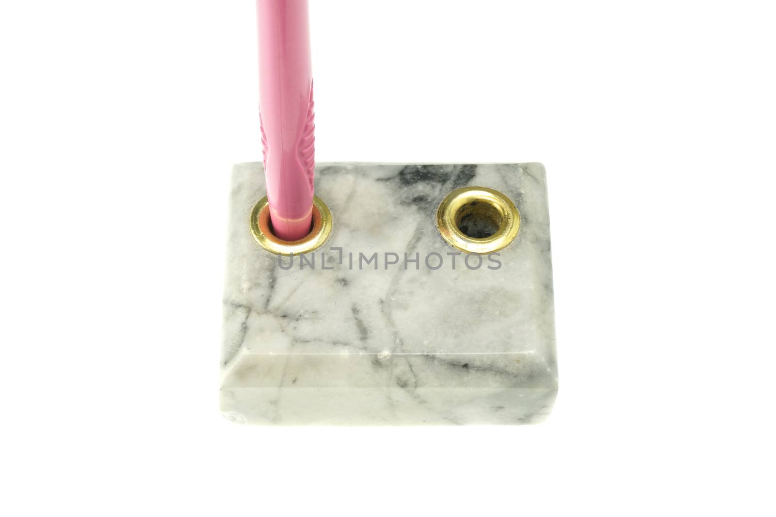 Pink pen in pen holder made from marble isolated with white background.