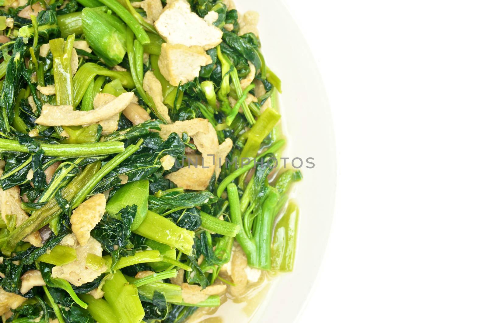 Spinach fried with tofu and Champignon mushroom isolated with white background.