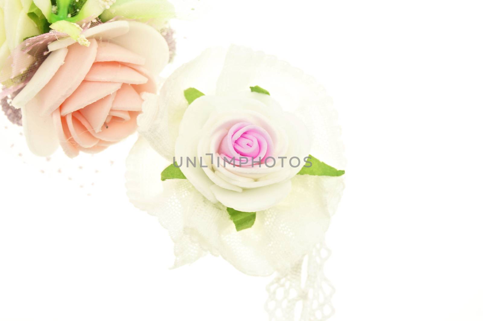 Vintage white and pink fabric flower isolated with white background.