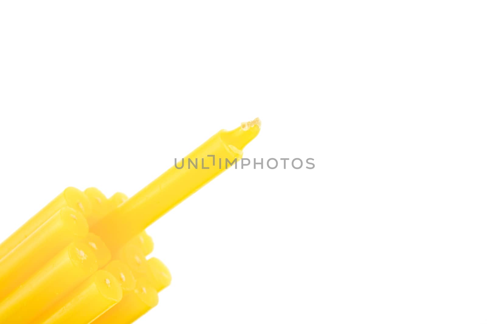 Yellow candle bundle on bottom left isolated with white background.