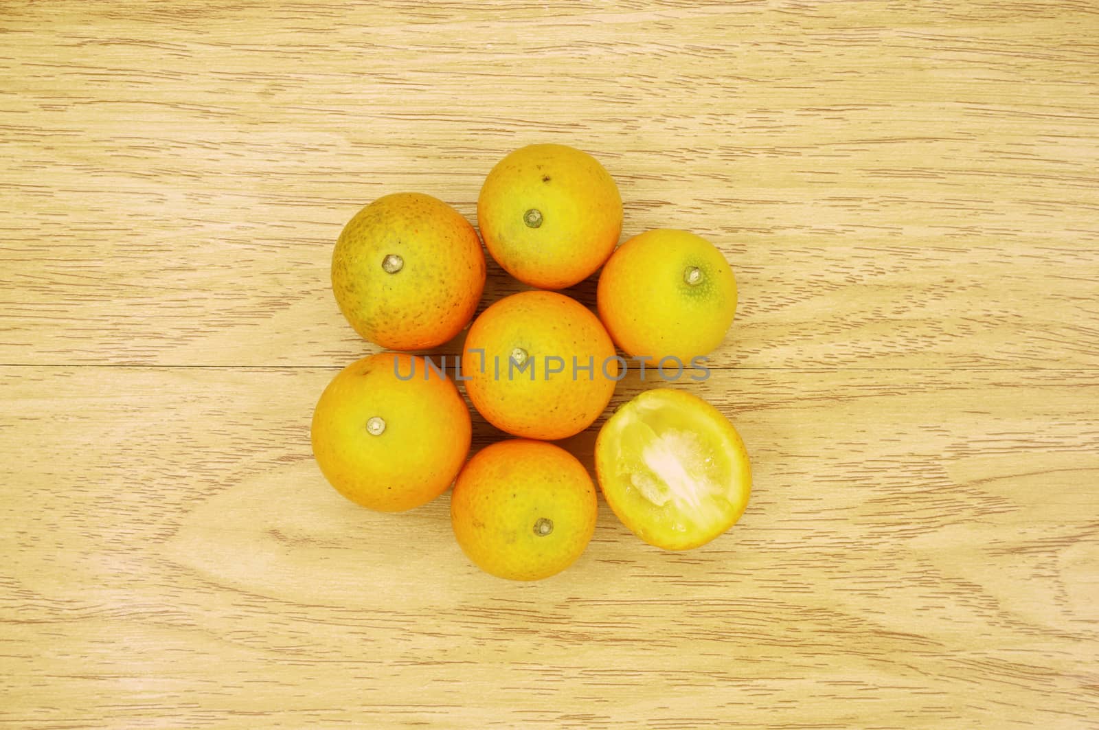 Small orange form china and sliced place on wood background.