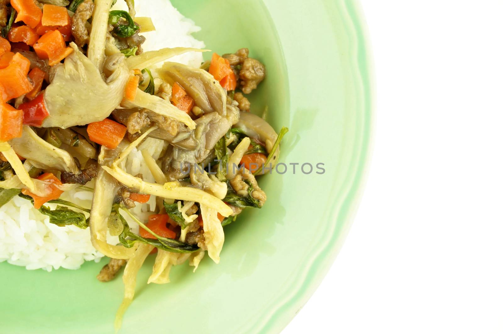 Close up carrot fried with oyster mushroom, vegan protein and basil on rice isolated white background.