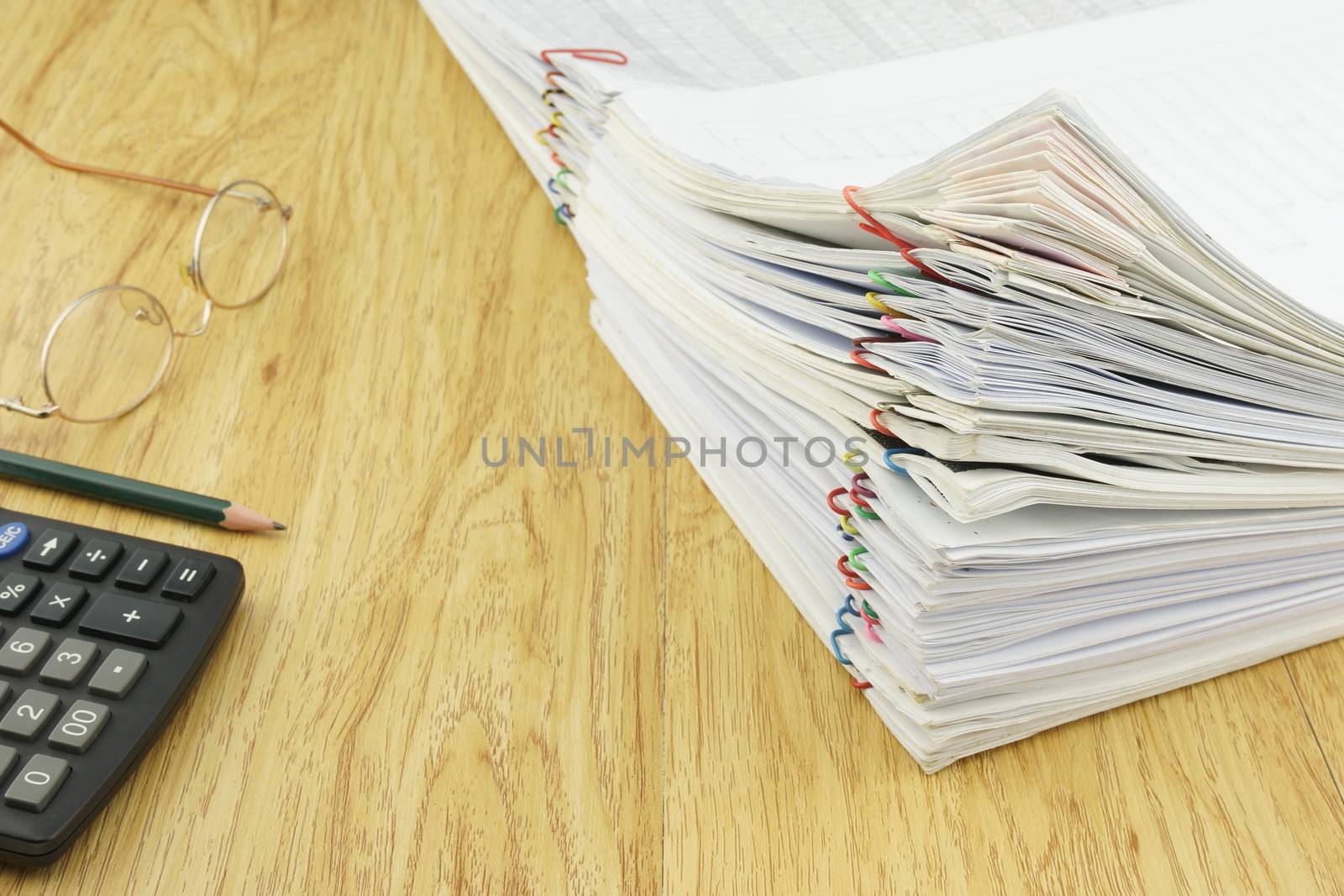 Document of account include sales and receipt place with calculator, pencil and glasses on wood background.