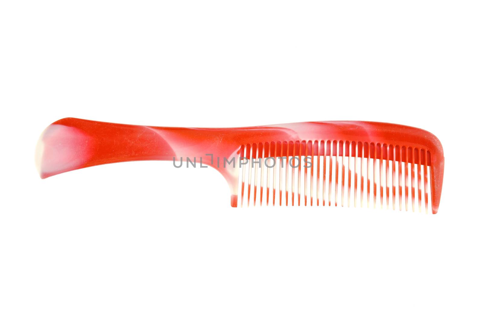 Red and white plastic comb placed isolated with white background.