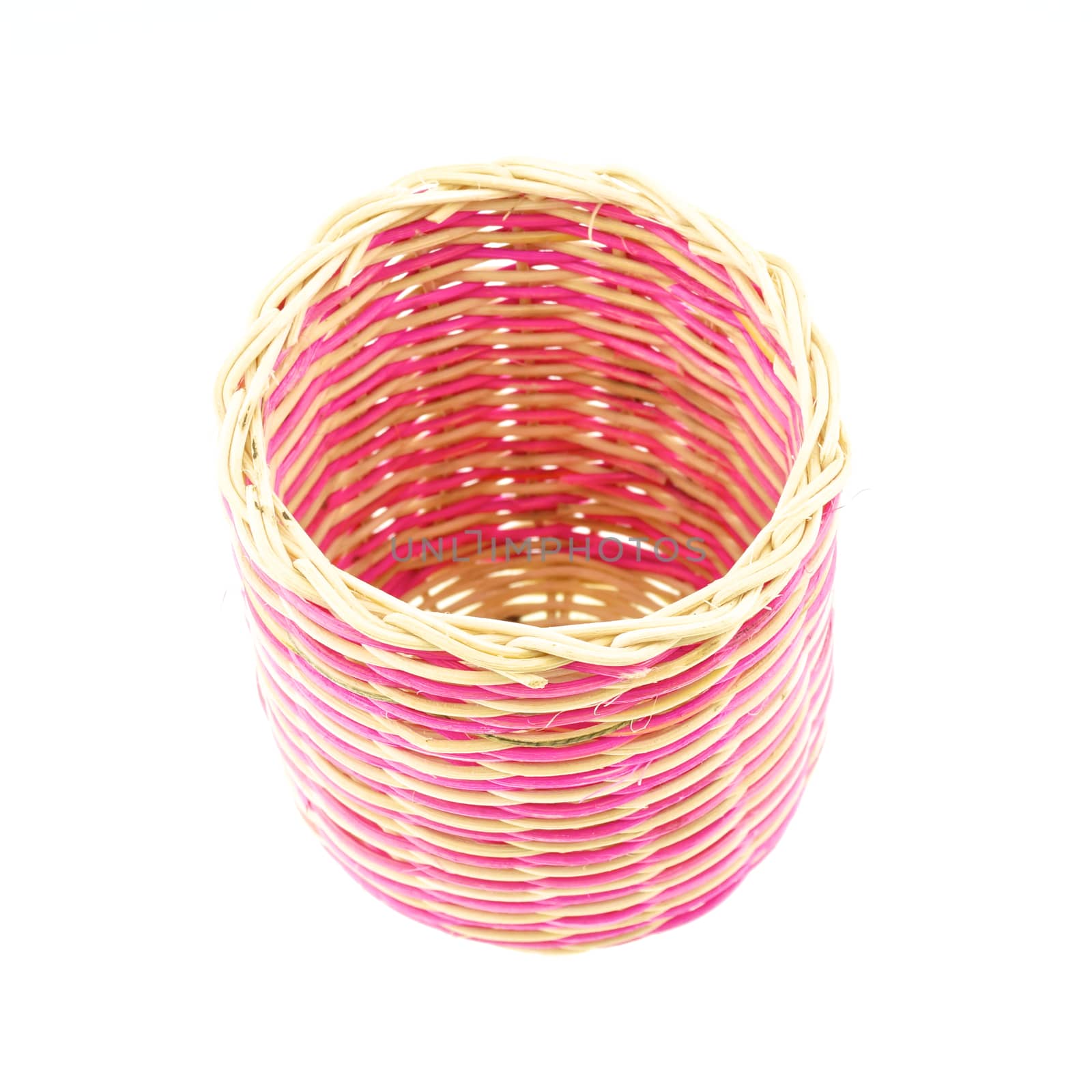 Pink wicker basket made from rattan isolated with white background.