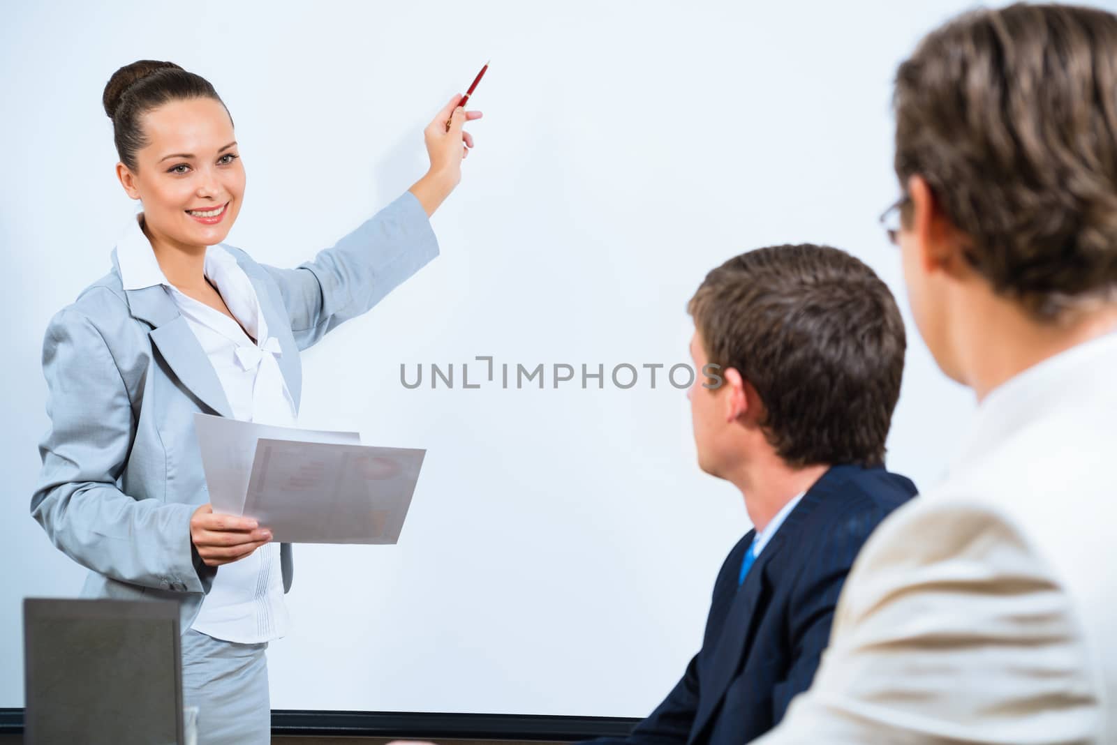 image of a Business woman showing a presentation to colleagues