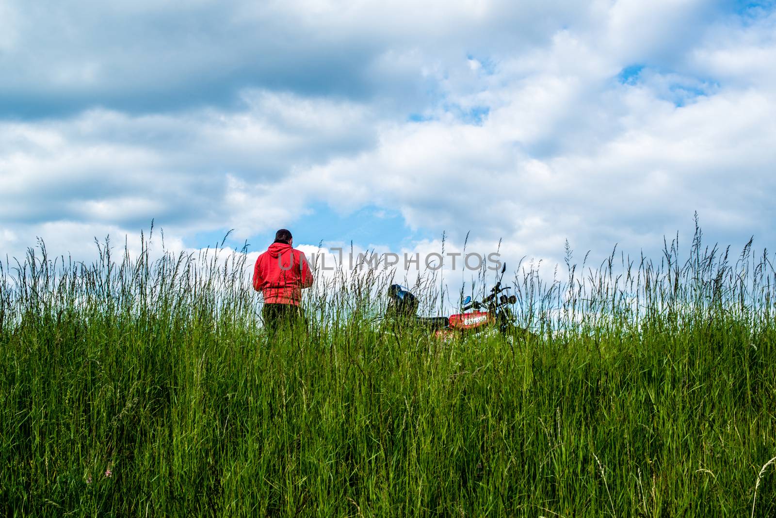 STUTTGART, GERMANY - MAY 17, 2014: A man with his moped is having a break in the fields around the airport in great weather on May, 17, 2014 in Stuttgart, Germany.