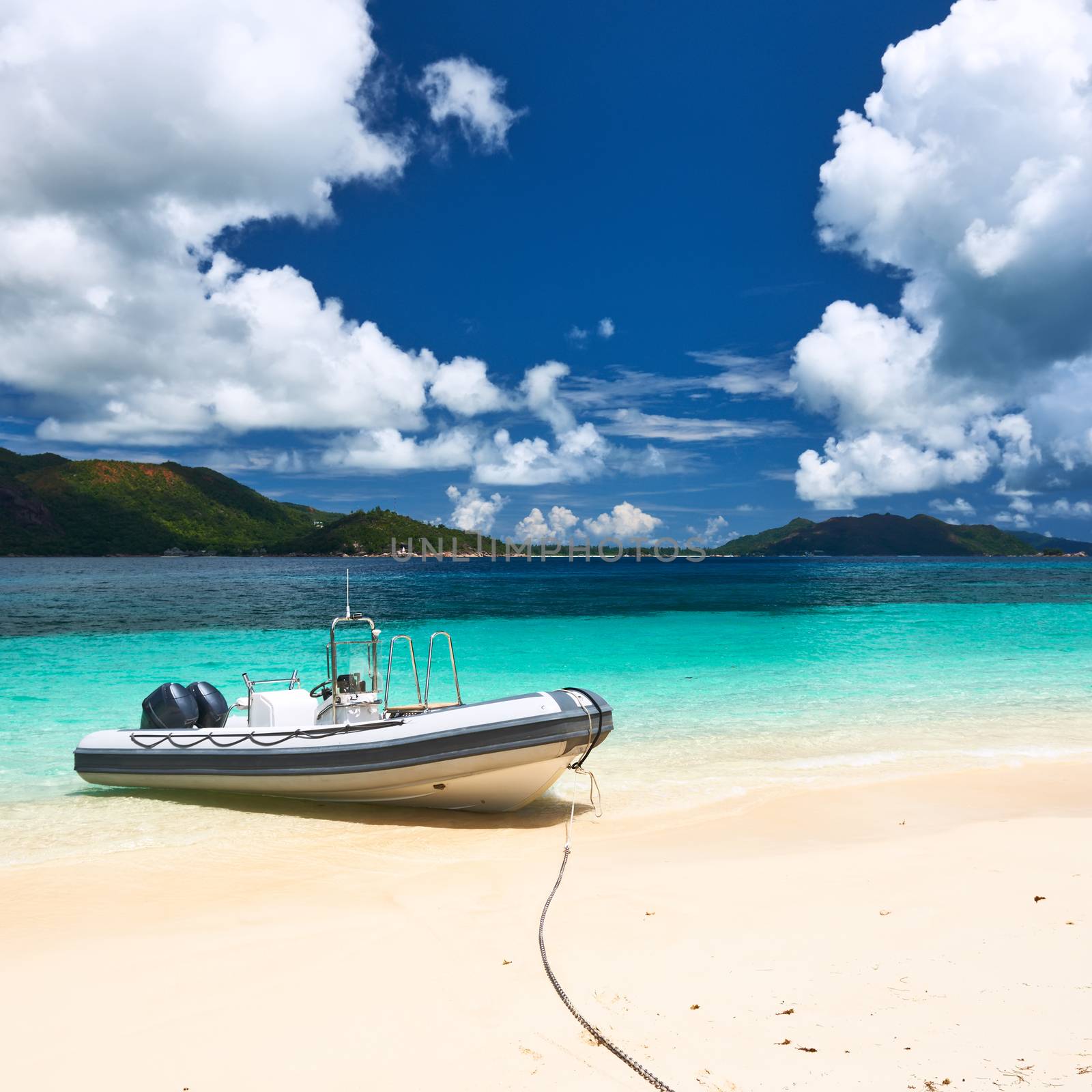 Tropical beach at Seychelles with inflatable boat by haveseen