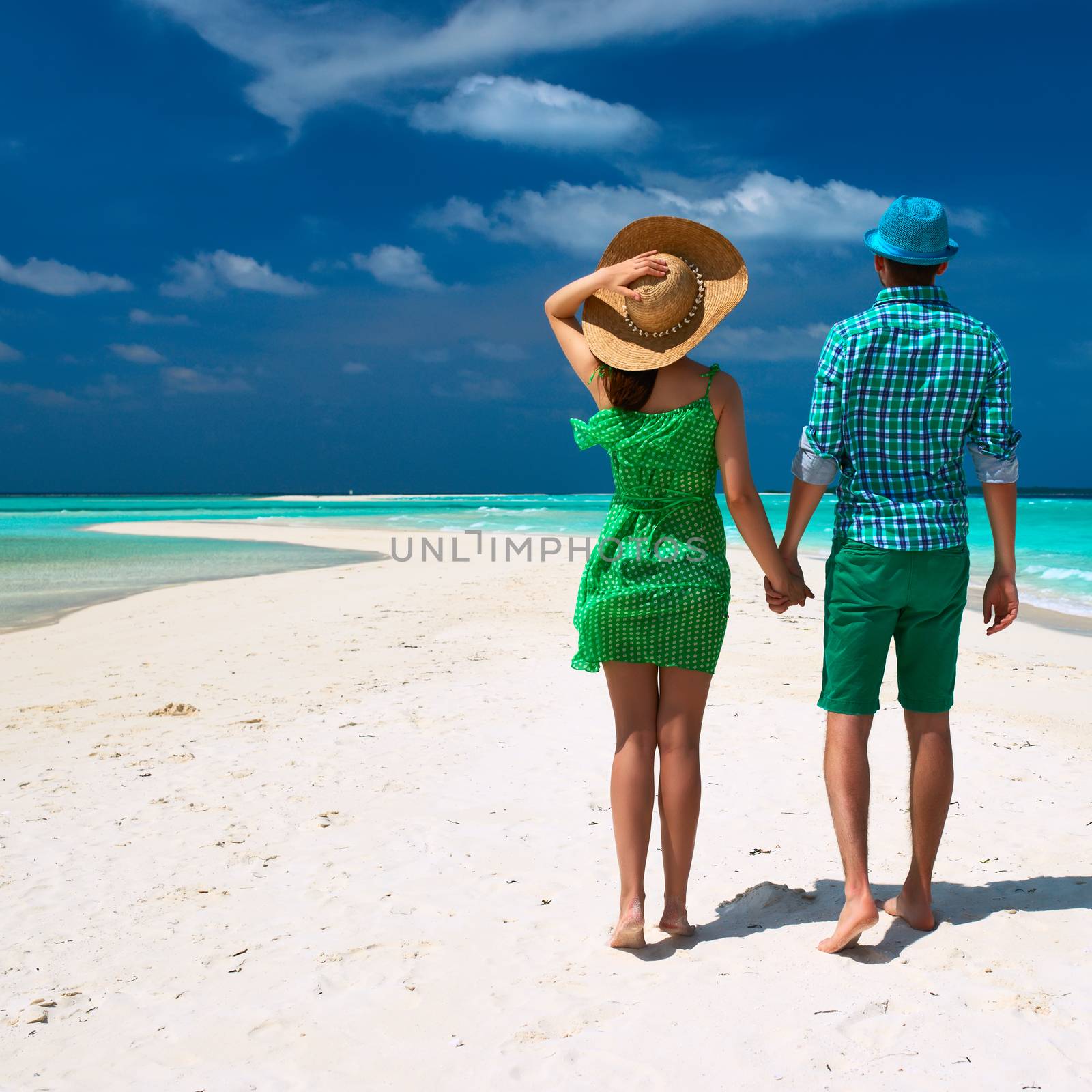 Couple in green on a tropical beach at Maldives