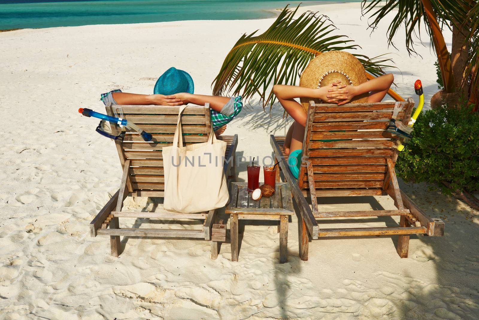 Couple in green on a tropical beach at Maldives