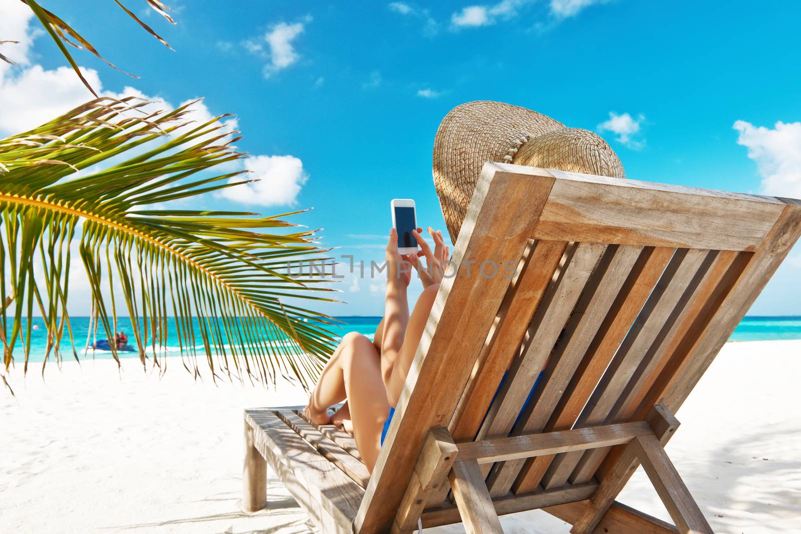 Young woman with tablet pc at the beach by haveseen