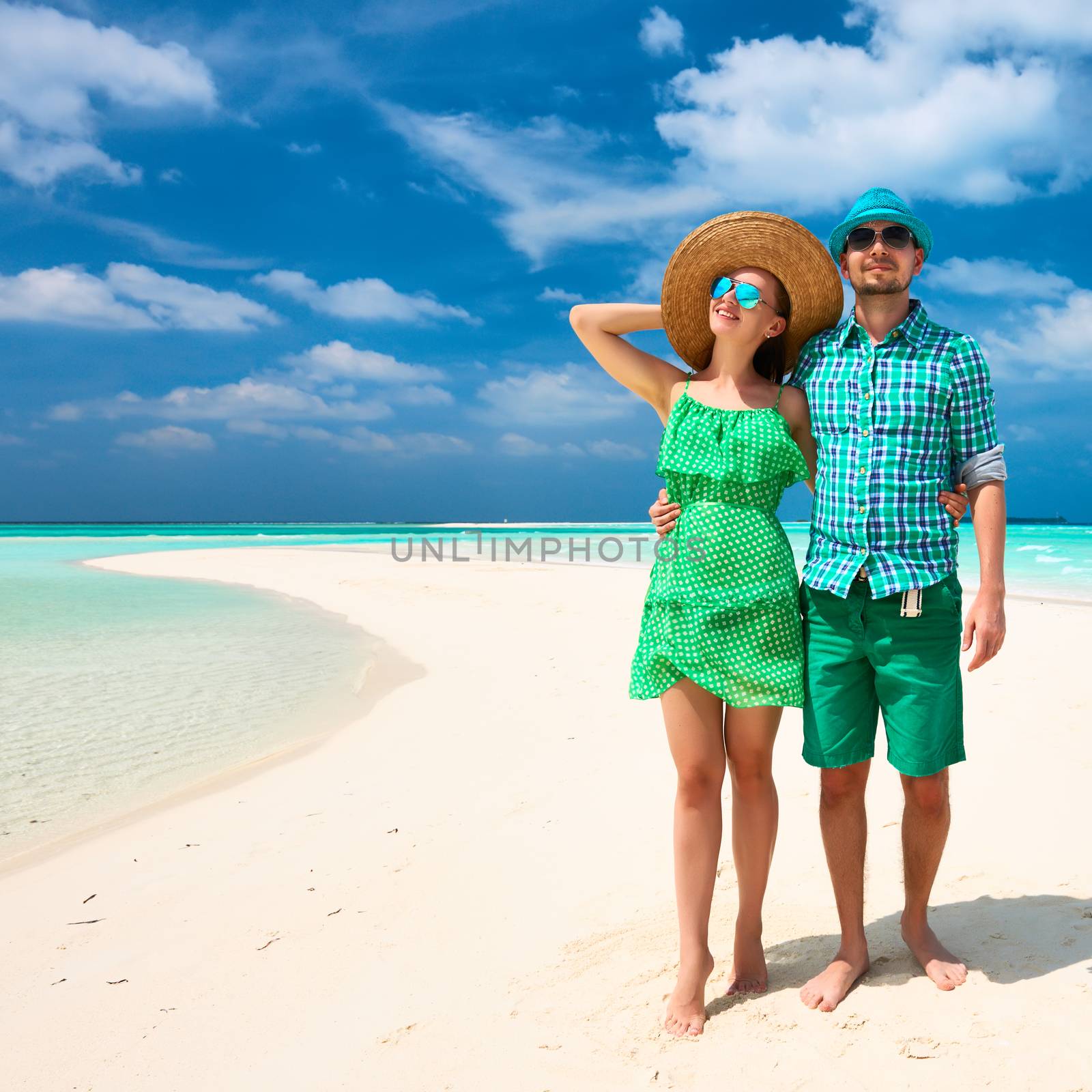 Couple in green on a tropical beach at Maldives