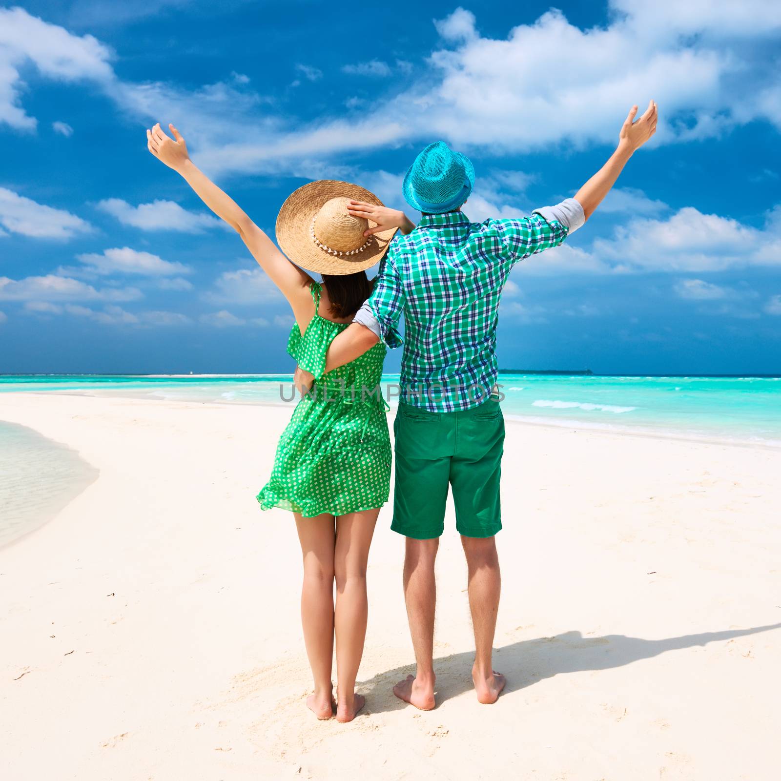 Couple in green on a tropical beach at Maldives