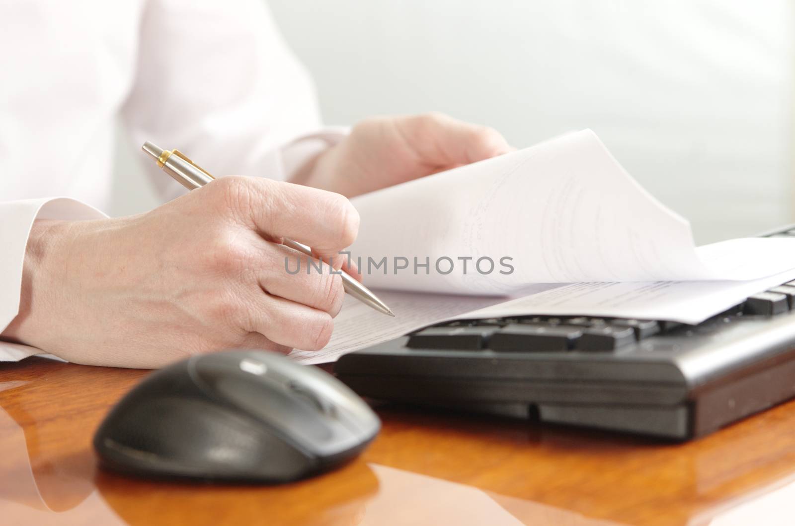 Hands with document on a computer keyboard by Ravenestling