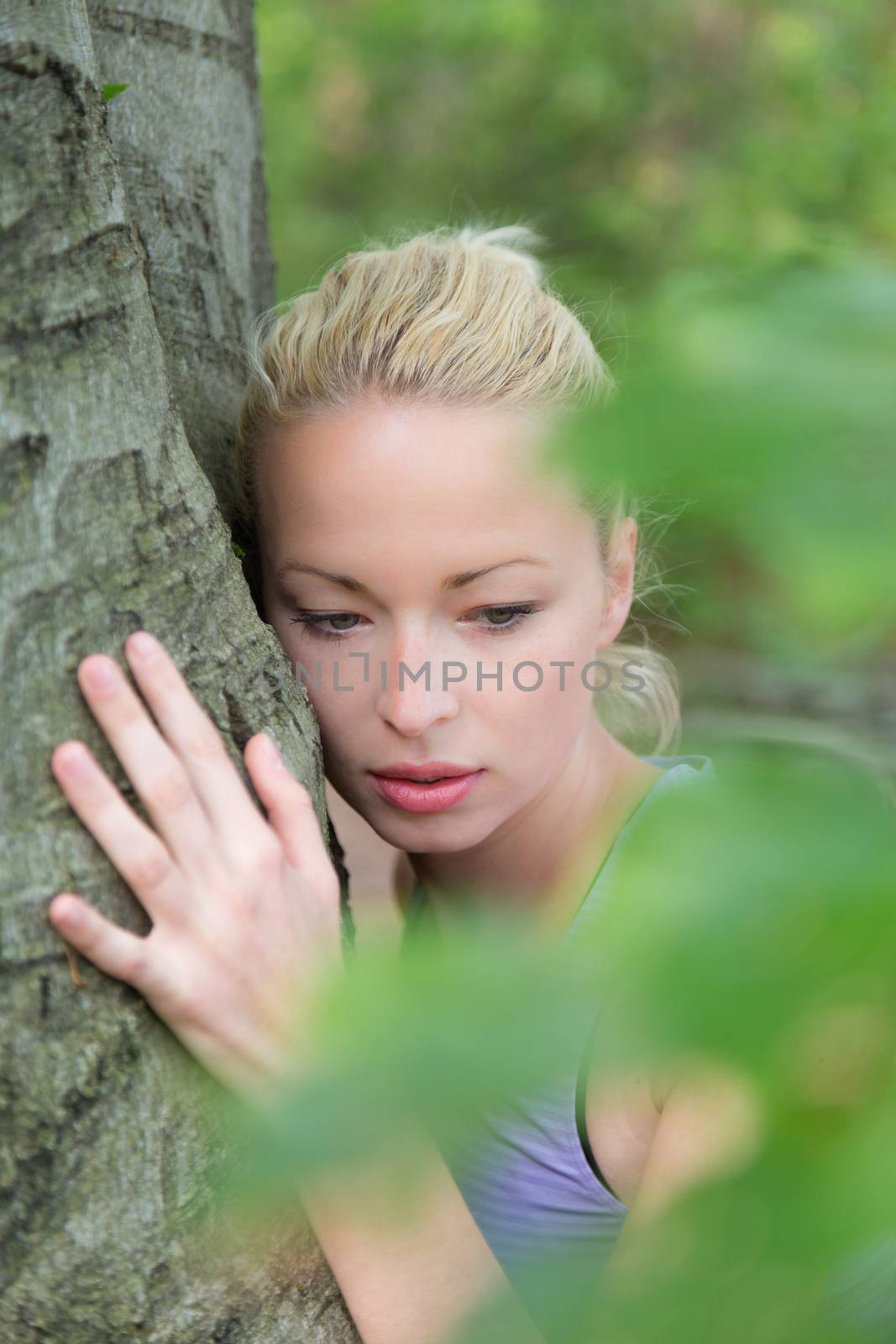 Young woman hugging a tree. by kasto
