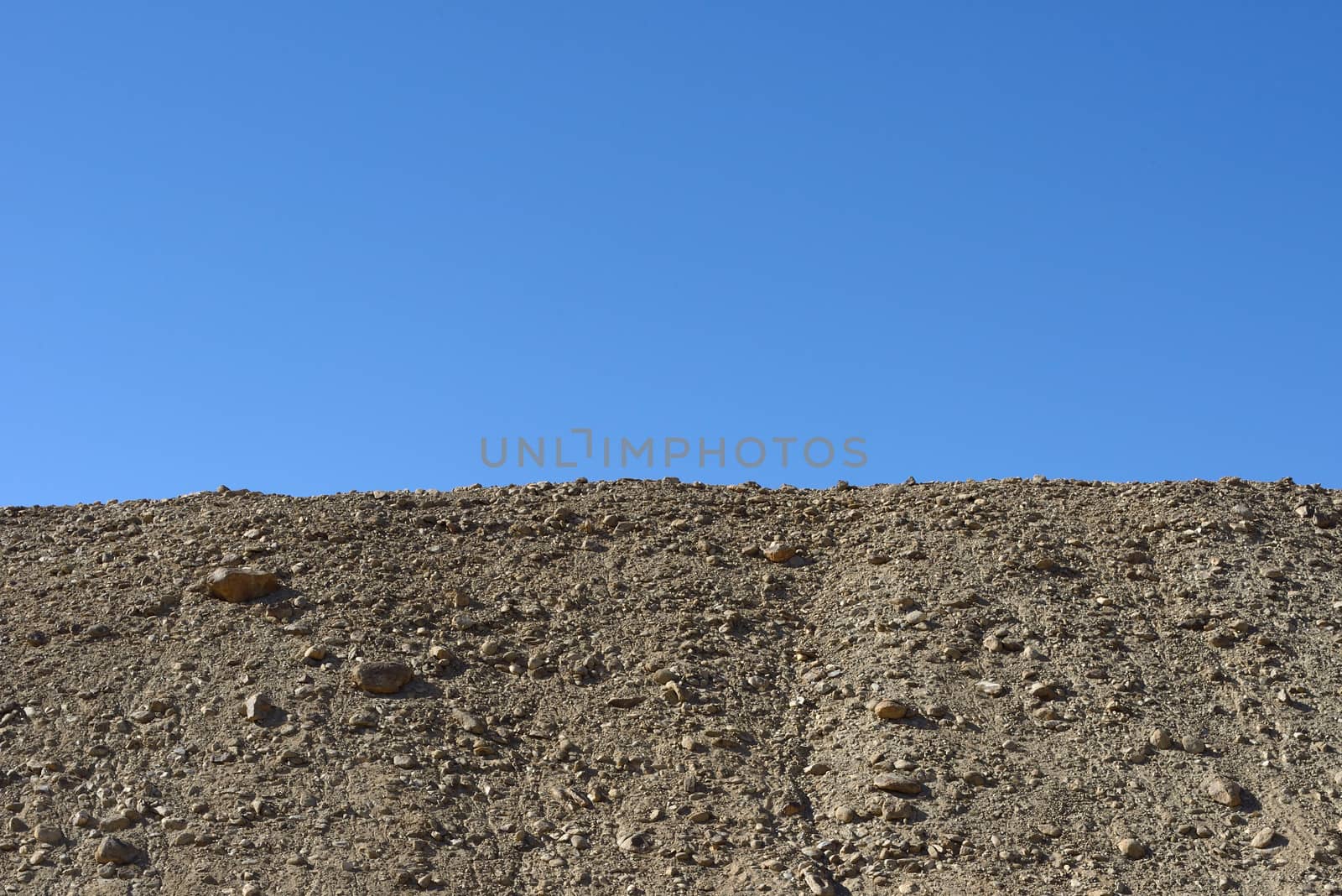 Rock mountain cliff over blue sky background by think4photop