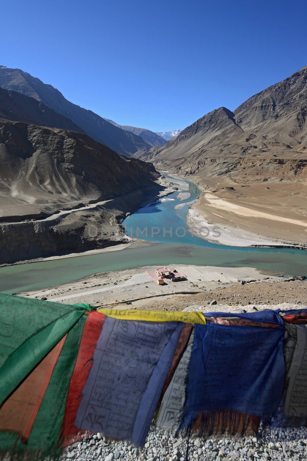 Confluence of Zanskar and Indus rivers and prayer flag- Leh, Ladakh, India