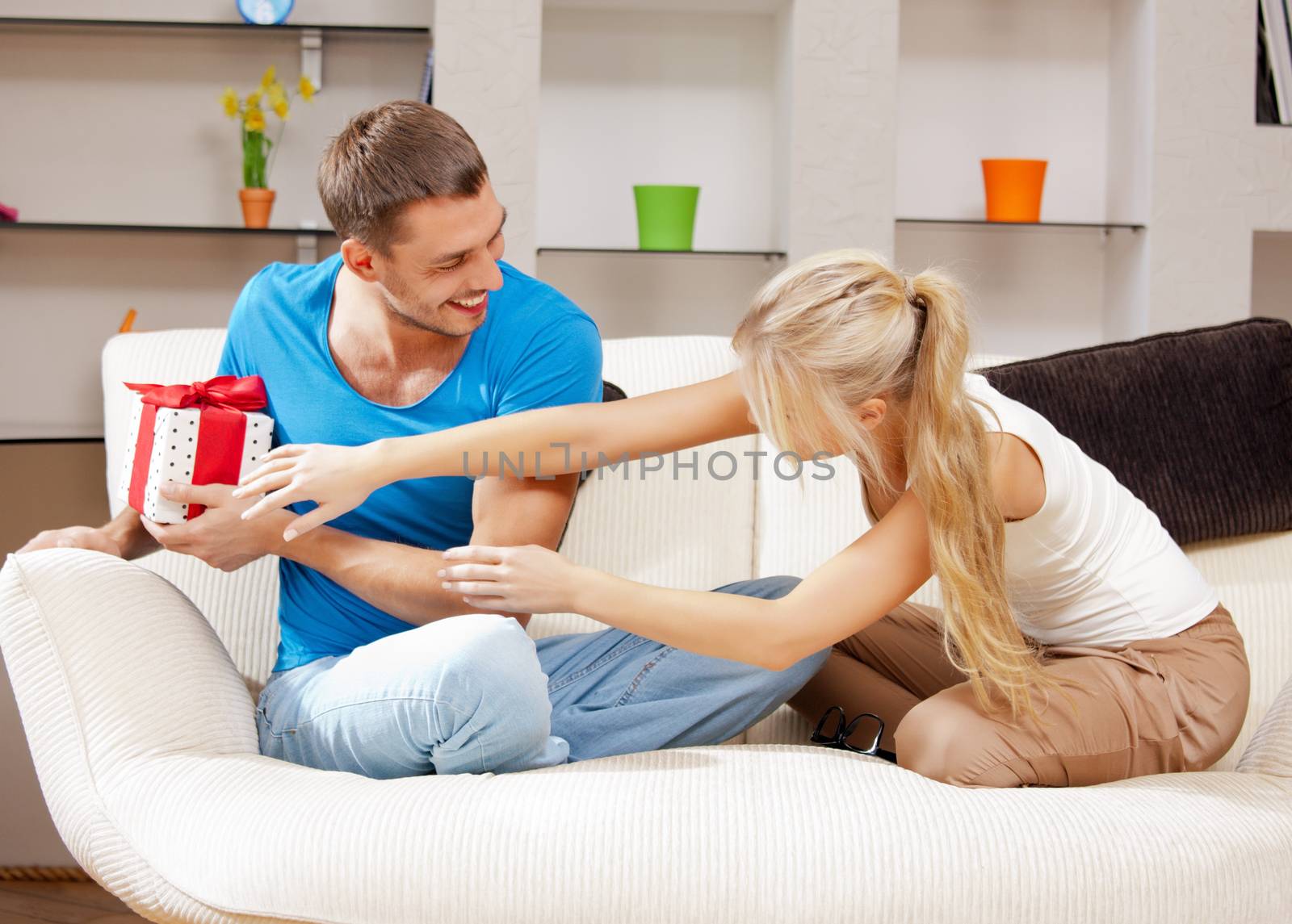 bright picture of happy romantic couple with gift (focus on man)