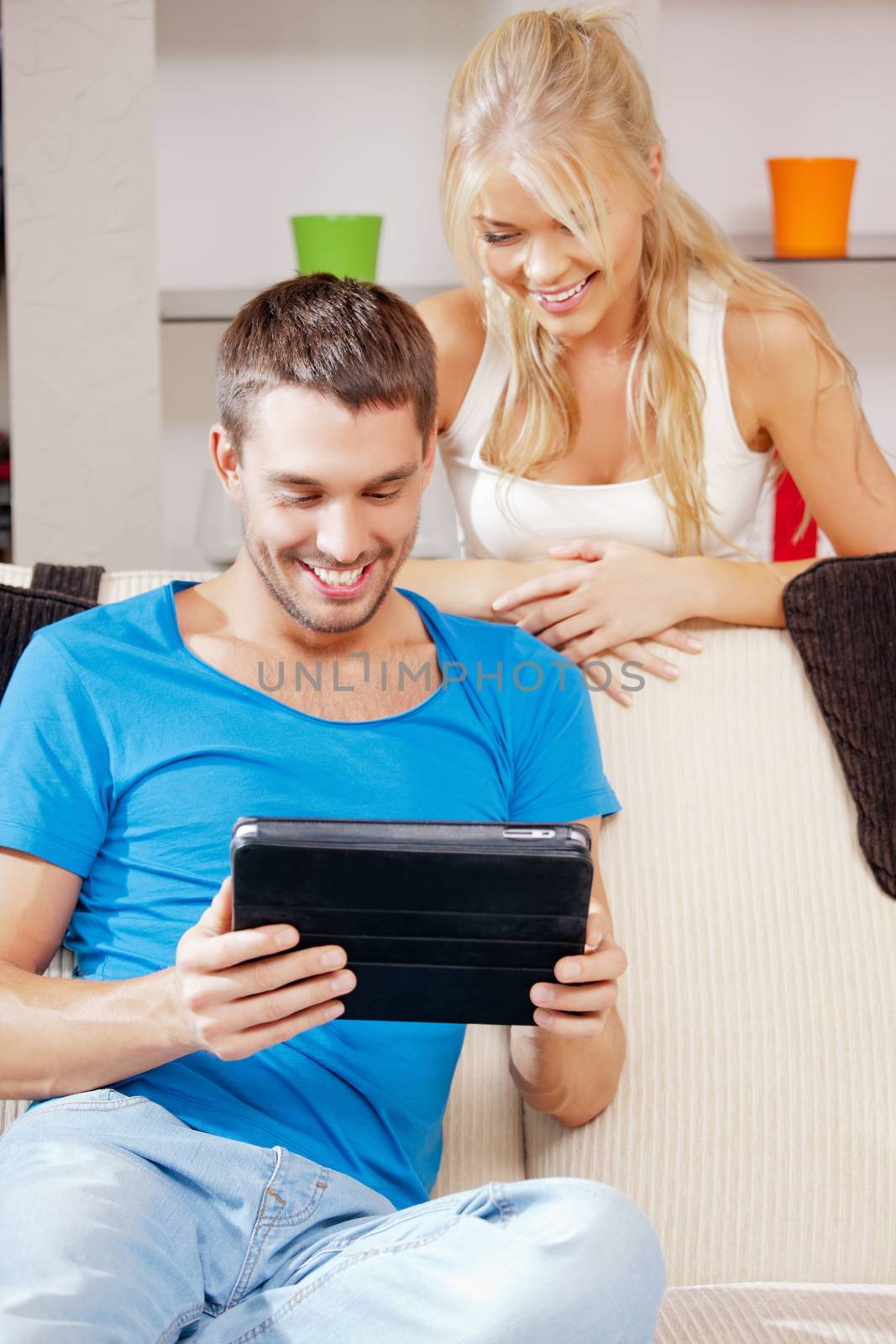 bright picture of happy couple with tablet PC