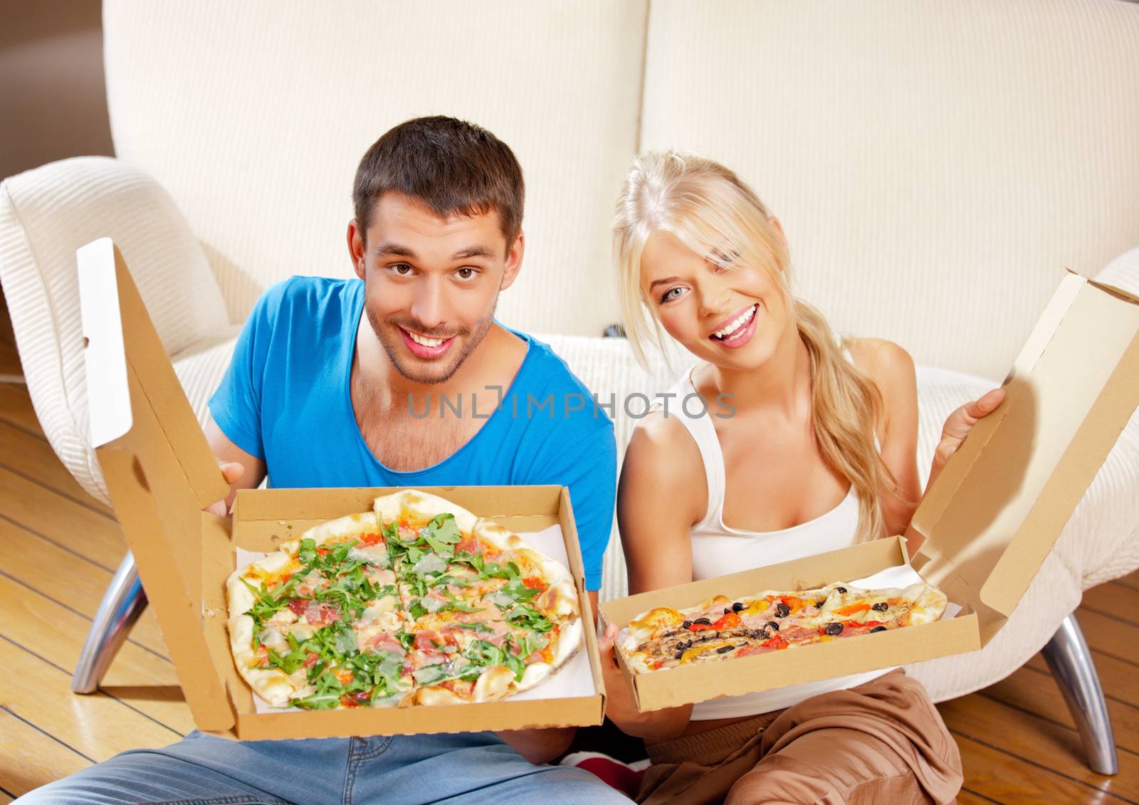 picture of happy romantic couple eating pizza at home