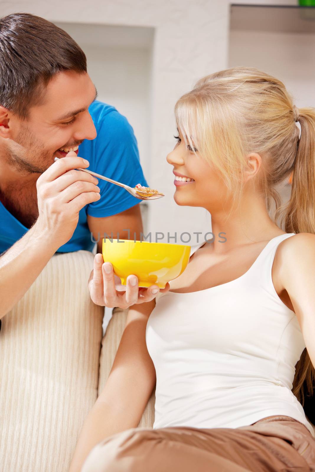 bright picture of happy couple with muesli (focus on man)