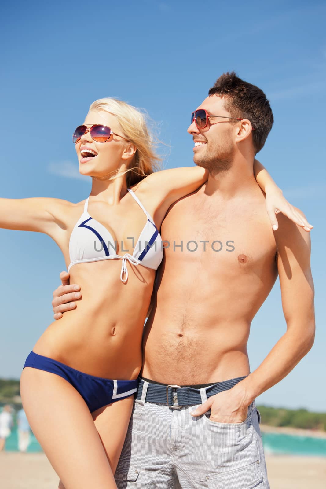 picture of happy couple in sunglasses on the beach.