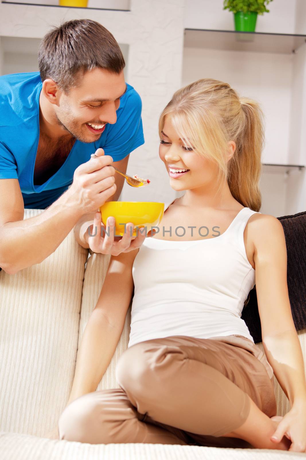 bright picture of happy couple with muesli (focus on man)