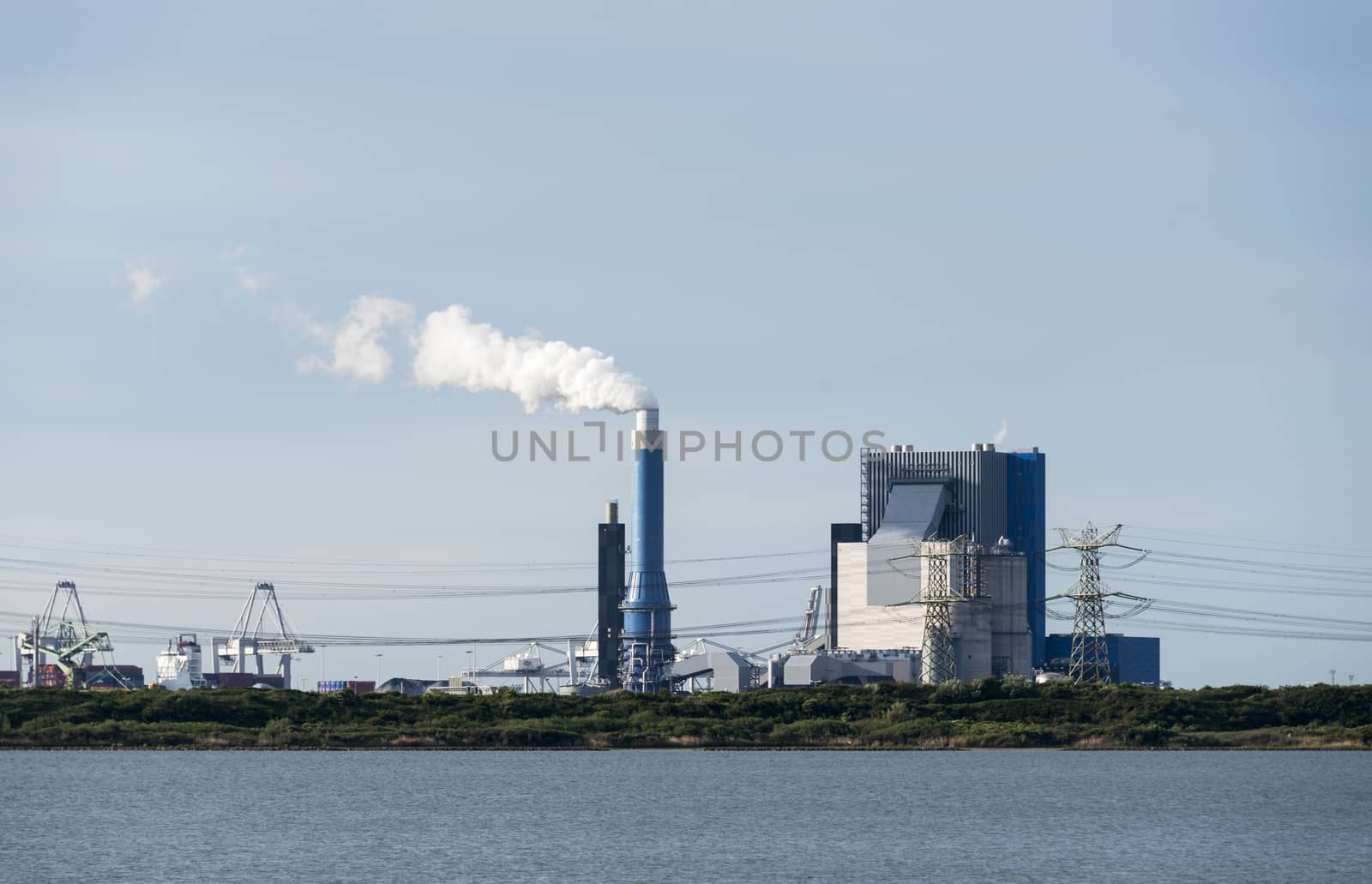 industrial skyline with cranes and power plant in Holland europoort