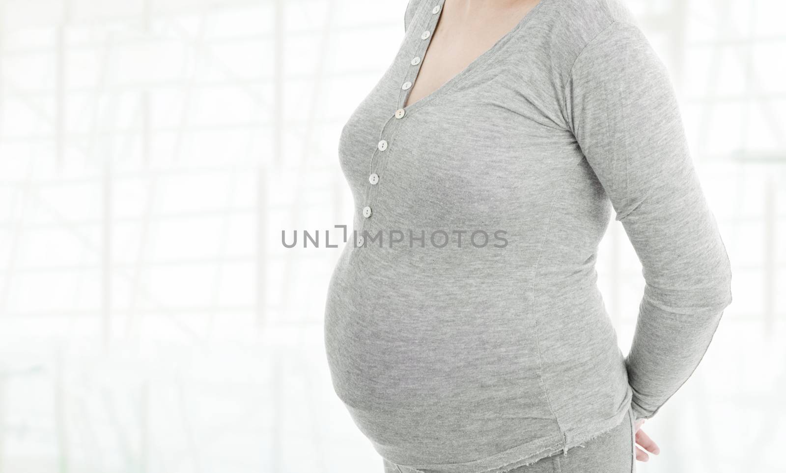 Closeup of pregnant woman at white background