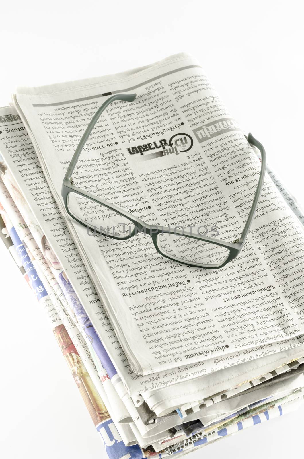 stack of newspaper with glasses by ammza12