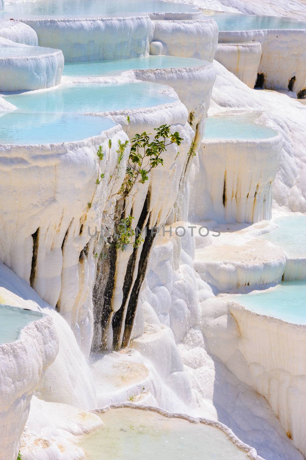 Blue cyan water travertine pools at ancient Hierapolis, now Pamukkale, Turkey