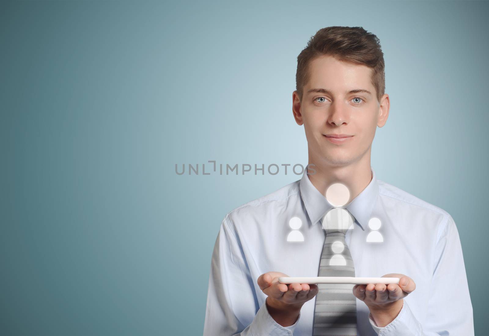 Businessman holding computer tablet with social media people icons in hands