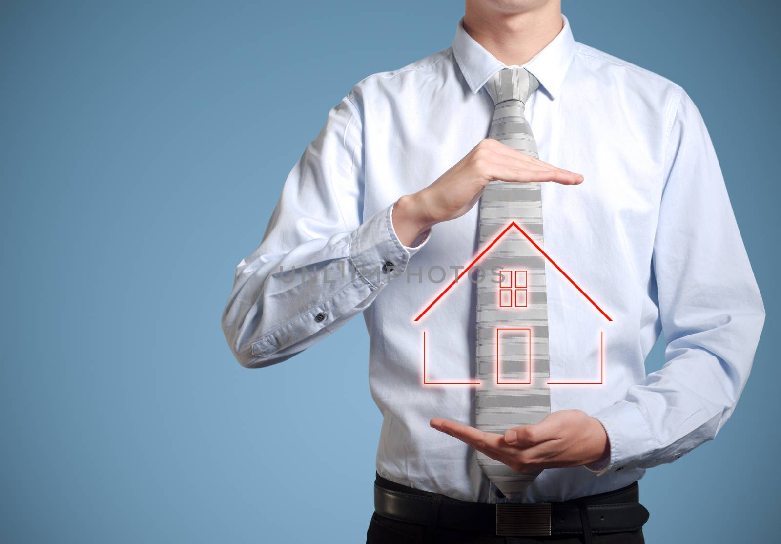 Businessman or banker man holding home or house in hands