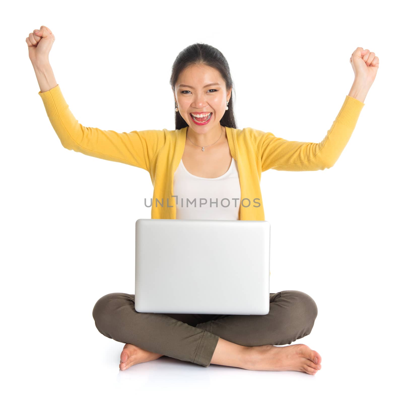 Asian girl arms up using laptop computer by szefei
