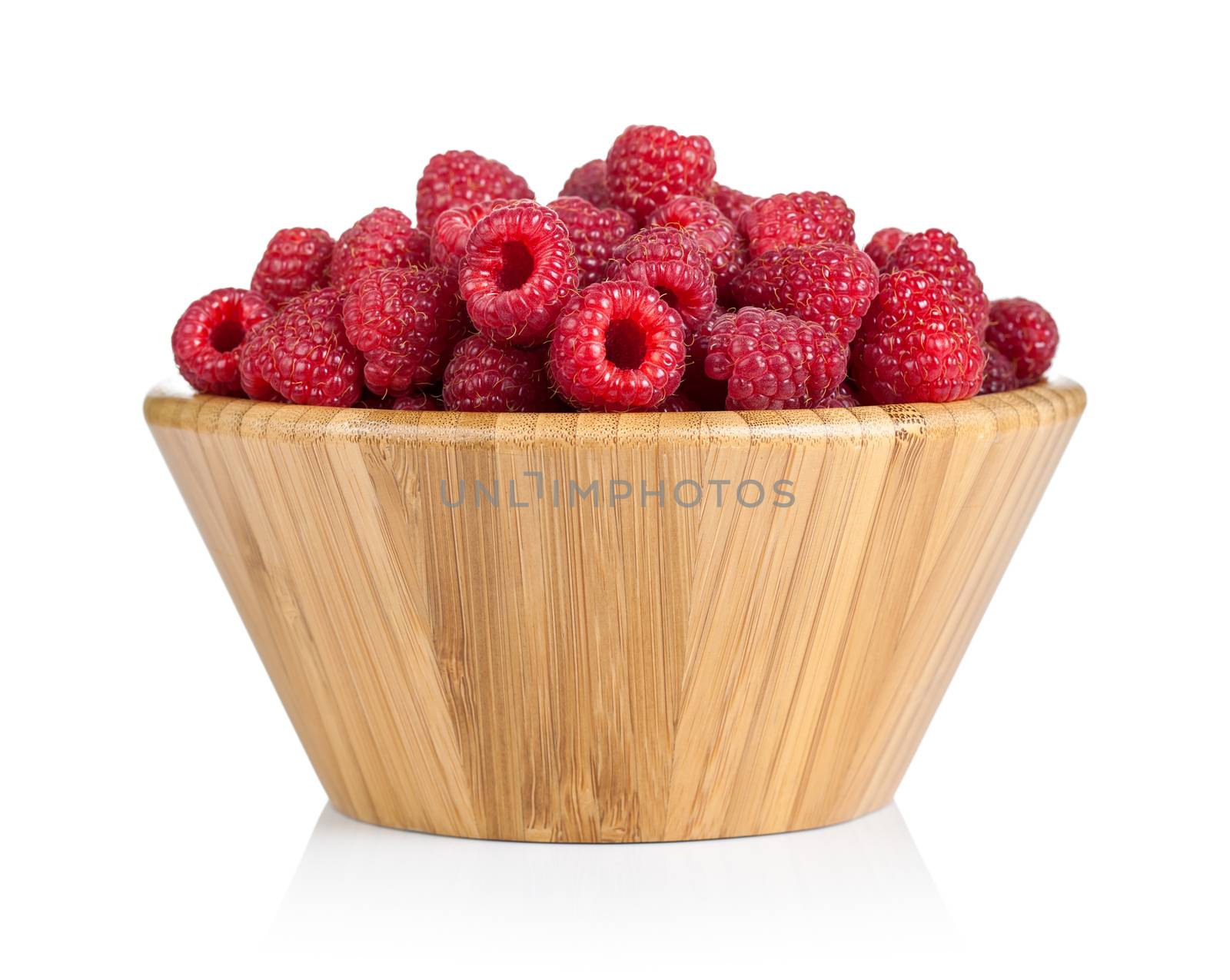 Raspberries in wooden bowl on white background