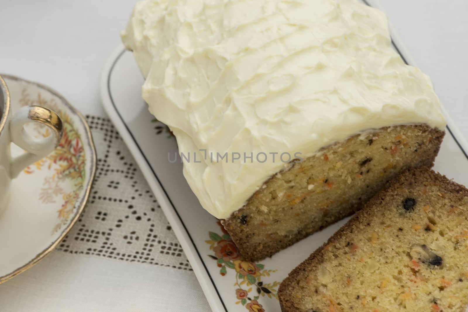 Beautiful and delicious homemade carrot cake on antique tableware with a cup of tea