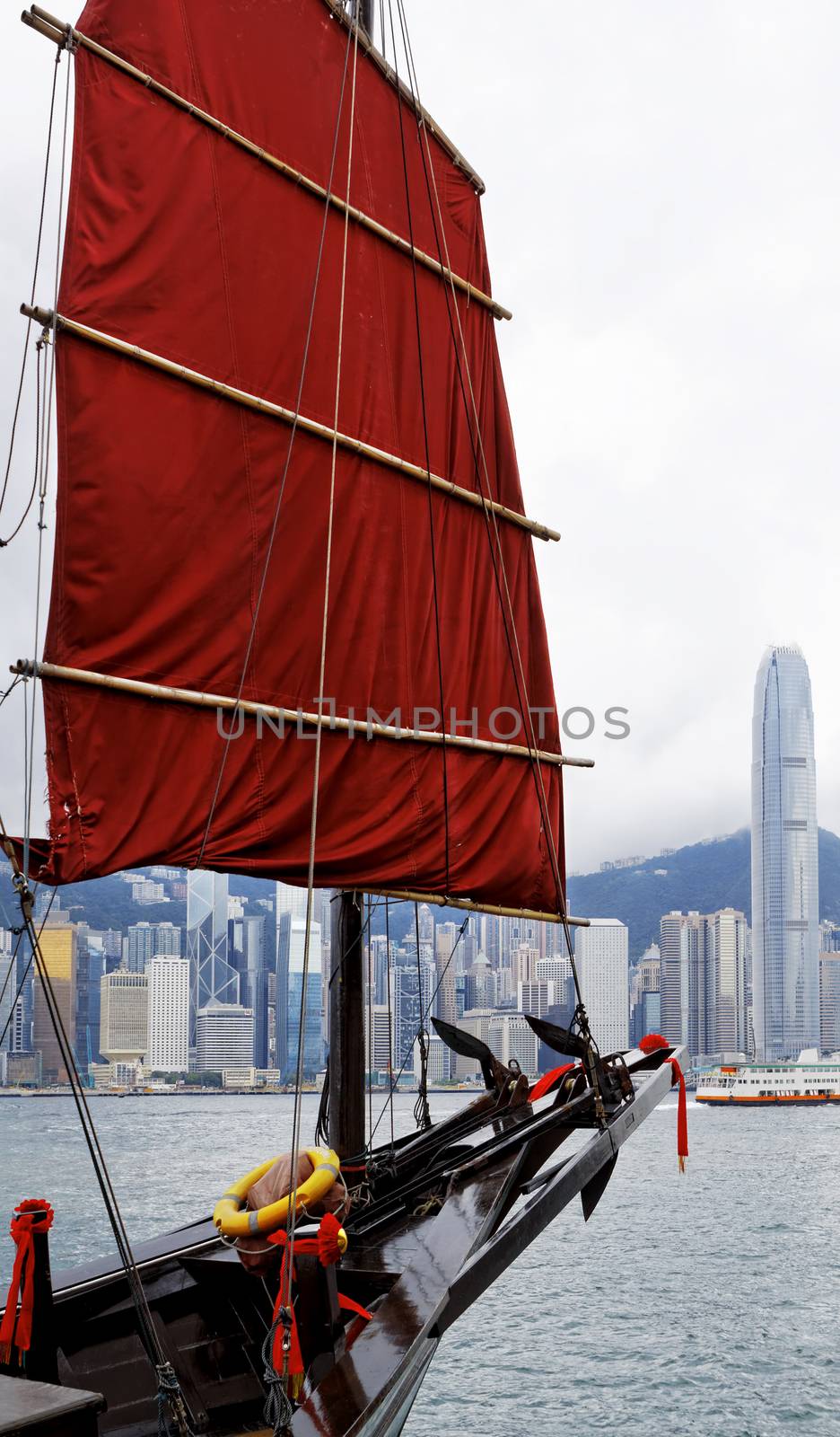orange wooden sailboat sailing in victoria harbor at Hong Kong 